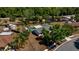 Aerial view of a home with mature trees, screened-in pool and fenced backyard for privacy and leisure at 3415 Sail Fish Ave, Fruitland Park, FL 34731