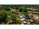 A home in a tree filled neighborhood featuring a screened-in pool and fenced yard at 3415 Sail Fish Ave, Fruitland Park, FL 34731