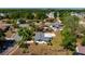 An aerial view of a home with a screened-in pool and fenced yard in a tranquil neighborhood at 3415 Sail Fish Ave, Fruitland Park, FL 34731