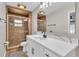 Stylish bathroom features a tiled shower and a quartz countertop vanity with black fixtures at 3415 Sail Fish Ave, Fruitland Park, FL 34731