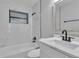 Beautiful bathroom with tub and shower combo, sleek vanity, black fixtures and modern finishes at 3415 Sail Fish Ave, Fruitland Park, FL 34731