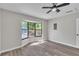 Bright bedroom with gray walls, updated flooring, a ceiling fan, and a bay window at 3415 Sail Fish Ave, Fruitland Park, FL 34731