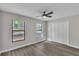 A bright bedroom features hardwood floors, a ceiling fan, and a closet with double doors at 3415 Sail Fish Ave, Fruitland Park, FL 34731