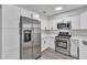 Modern kitchen featuring stainless steel appliances, white cabinets, and sleek countertops at 3415 Sail Fish Ave, Fruitland Park, FL 34731
