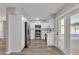 Bright kitchen with stainless steel appliances, white cabinets, and an open layout with wood grain flooring at 3415 Sail Fish Ave, Fruitland Park, FL 34731