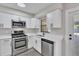 Updated kitchen with stainless steel appliances, white cabinetry, and contemporary finishes at 3415 Sail Fish Ave, Fruitland Park, FL 34731