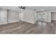 Open-concept living room featuring wood floors and a ceiling fan with doors leading to the backyard at 3415 Sail Fish Ave, Fruitland Park, FL 34731