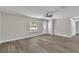 Bright living room with wood grain flooring, a large window, and a ceiling fan at 3415 Sail Fish Ave, Fruitland Park, FL 34731