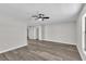 A living room showcases wood-look flooring, a ceiling fan, and views into other rooms at 3415 Sail Fish Ave, Fruitland Park, FL 34731