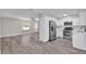 Open living space with wood grain floors that seamlessly connects to a modern kitchen at 3415 Sail Fish Ave, Fruitland Park, FL 34731
