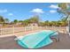 Refreshing backyard pool with clear water, enclosed by a white picket fence and mature landscaping at 3415 Sail Fish Ave, Fruitland Park, FL 34731