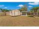 Fenced backyard with storage sheds at 3415 Sail Fish Ave, Fruitland Park, FL 34731