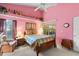 Cozy bedroom with a warm-toned walls, a window, and a decorative shelf at 3603 Westerham Dr, Clermont, FL 34711