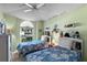Charming bedroom with dual beds, soft green walls, and whimsical decor at 3603 Westerham Dr, Clermont, FL 34711