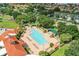 High angle view of community pool with lounge chairs, a spa, and verdant tropical landscaping at 3603 Westerham Dr, Clermont, FL 34711