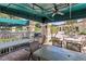 Outdoor grilling area featuring seating, tables, and a grill overlooking the community pool at 3603 Westerham Dr, Clermont, FL 34711