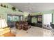 Spacious living room features tile flooring, bright green walls, and sliding glass doors to the patio at 3603 Westerham Dr, Clermont, FL 34711