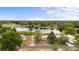 Aerial view of homes shows lake, neighborhood, landscaping, and fenced yard at 37132 Turner Dr, Umatilla, FL 32784