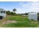 Property featuring a large backyard adjacent to a pond and a storage shed at 37132 Turner Dr, Umatilla, FL 32784