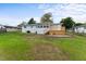 Large backyard featuring a spacious lawn, wood deck, and screened-in porch at 37132 Turner Dr, Umatilla, FL 32784