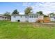 Spacious backyard with lush green grass, wood deck and a well-maintained lawn at 37132 Turner Dr, Umatilla, FL 32784