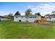 Expansive backyard with lush green grass and a charming wood deck at 37132 Turner Dr, Umatilla, FL 32784