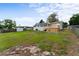 Grassy backyard features a shed, small deck, and a partially fenced yard at 37132 Turner Dr, Umatilla, FL 32784