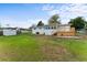 Large backyard featuring a spacious lawn, wood deck, and screened-in porch at 37132 Turner Dr, Umatilla, FL 32784