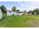 Large backyard featuring lush green grass and a charming wood deck at 37132 Turner Dr, Umatilla, FL 32784