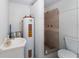 Functional bathroom with a shower, toilet, and sink next to a water heater at 37132 Turner Dr, Umatilla, FL 32784