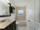 Bright bathroom featuring a vanity with sink, tub with shower and large mirror at 37132 Turner Dr, Umatilla, FL 32784