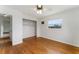 Comfortable bedroom with hardwood floors, window overlooking nature and closet with shelving at 37132 Turner Dr, Umatilla, FL 32784
