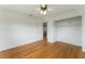 Charming bedroom featuring hardwood floors, a ceiling fan, and a spacious closet with shelving at 37132 Turner Dr, Umatilla, FL 32784