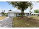 Charming single-story home features a well-manicured lawn, mature shade tree, and inviting curb appeal at 37132 Turner Dr, Umatilla, FL 32784