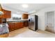 Functional kitchen featuring a stainless steel refrigerator and wooden cabinets at 37132 Turner Dr, Umatilla, FL 32784