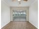 Bright living room featuring sleek wood flooring and a glass-enclosed patio with scenic views at 37132 Turner Dr, Umatilla, FL 32784