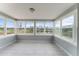 Bright sunroom with large windows offering stunning views of the lake and backyard at 37132 Turner Dr, Umatilla, FL 32784