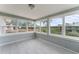 Bright sunroom with large windows offering stunning views of the lake and backyard at 37132 Turner Dr, Umatilla, FL 32784