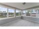 Bright sunroom with large windows offering views of the lake and surrounding neighborhood at 37132 Turner Dr, Umatilla, FL 32784