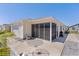Backyard featuring a screened lanai, a table, and a grill for outdoor entertaining at 3756 Viscaya Ct, The Villages, FL 32163