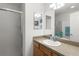 Bathroom featuring a glass enclosed shower, modern sink, and large mirror at 3756 Viscaya Ct, The Villages, FL 32163