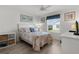 Sunlit bedroom features a cozy bed, a ceiling fan, and a view of the neighborhood at 3756 Viscaya Ct, The Villages, FL 32163