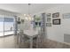 Bright dining room with a white table, four chairs, wood floors, and sliding glass doors to outdoor patio at 3756 Viscaya Ct, The Villages, FL 32163