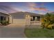 Charming one-story home with a well-manicured lawn, picket fence, and attached garage at 3756 Viscaya Ct, The Villages, FL 32163
