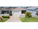 Charming single Gathering home with a two-car garage, well-kept lawn, and cozy front screened in porch at 3756 Viscaya Ct, The Villages, FL 32163