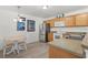 Bright kitchen area with a stainless steel refrigerator and a cozy breakfast table at 3756 Viscaya Ct, The Villages, FL 32163
