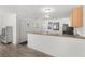 View of kitchen from adjacent room showing a breakfast bar at 3756 Viscaya Ct, The Villages, FL 32163