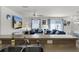 Living room with comfortable blue seating adjacent to kitchen for seamless entertaining at 3756 Viscaya Ct, The Villages, FL 32163