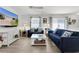 Comfortable living area featuring blue sofas, contemporary decor, and large screen television providing ample seating at 3756 Viscaya Ct, The Villages, FL 32163