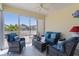 Relaxing screened in patio with ceiling fan and comfortable seating area to enjoy sunny days and cool evenings at 3756 Viscaya Ct, The Villages, FL 32163